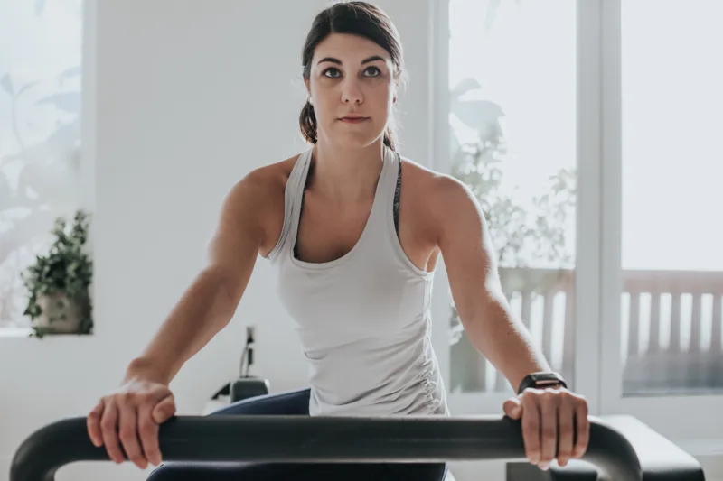 A pilates instructor - A female practising pilates
