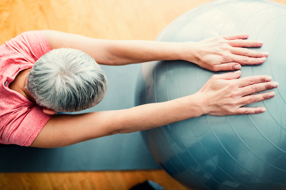 woman using pilates excercise ball