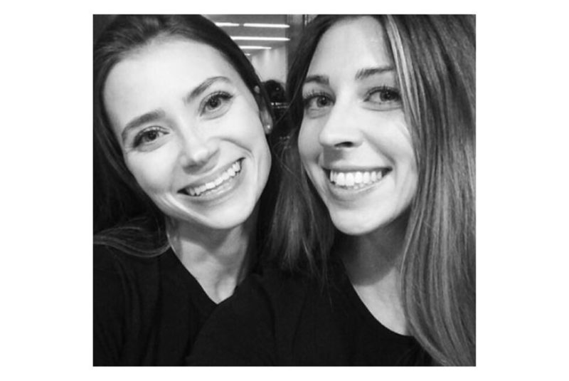 Living consciously - Two females smiling at the camera, black and white.
