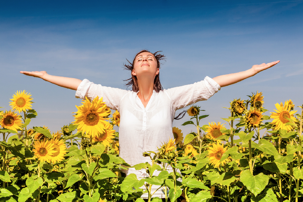 Breathe Easy week 2019 - Girl inhaling fresh air in amongst sunflowers