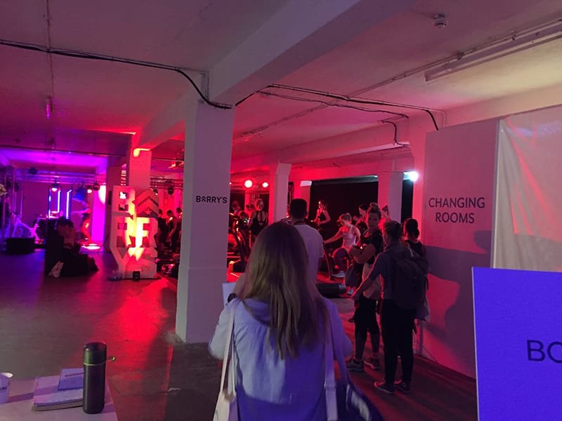 wellness festival - underground studio with individuals on fitness equipment and mood lighting