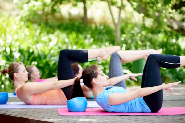 The Pilates Hundred - External shot of women performing a modified version of the Pilates Hundred