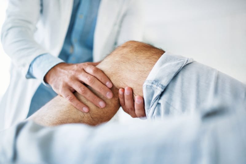 What is Pain? - Man's knee being treated by a Physiotherapist