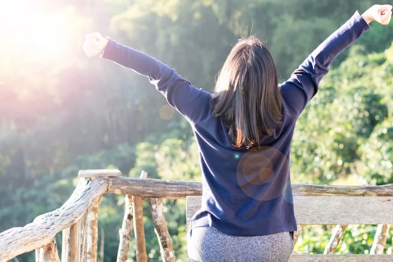 Woman stretching and breathing in outdoors-min