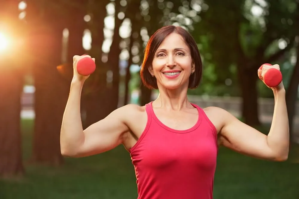 woman with hand weights managing osteoporosis