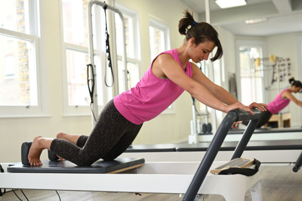 knee stretches reformer Complete Pilates