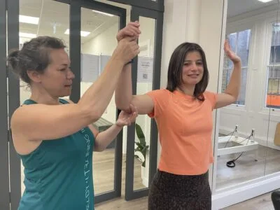physio assessing shoulder range Complete Pilates