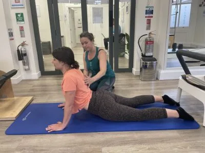 physio assessing shoulder range Complete Pilates