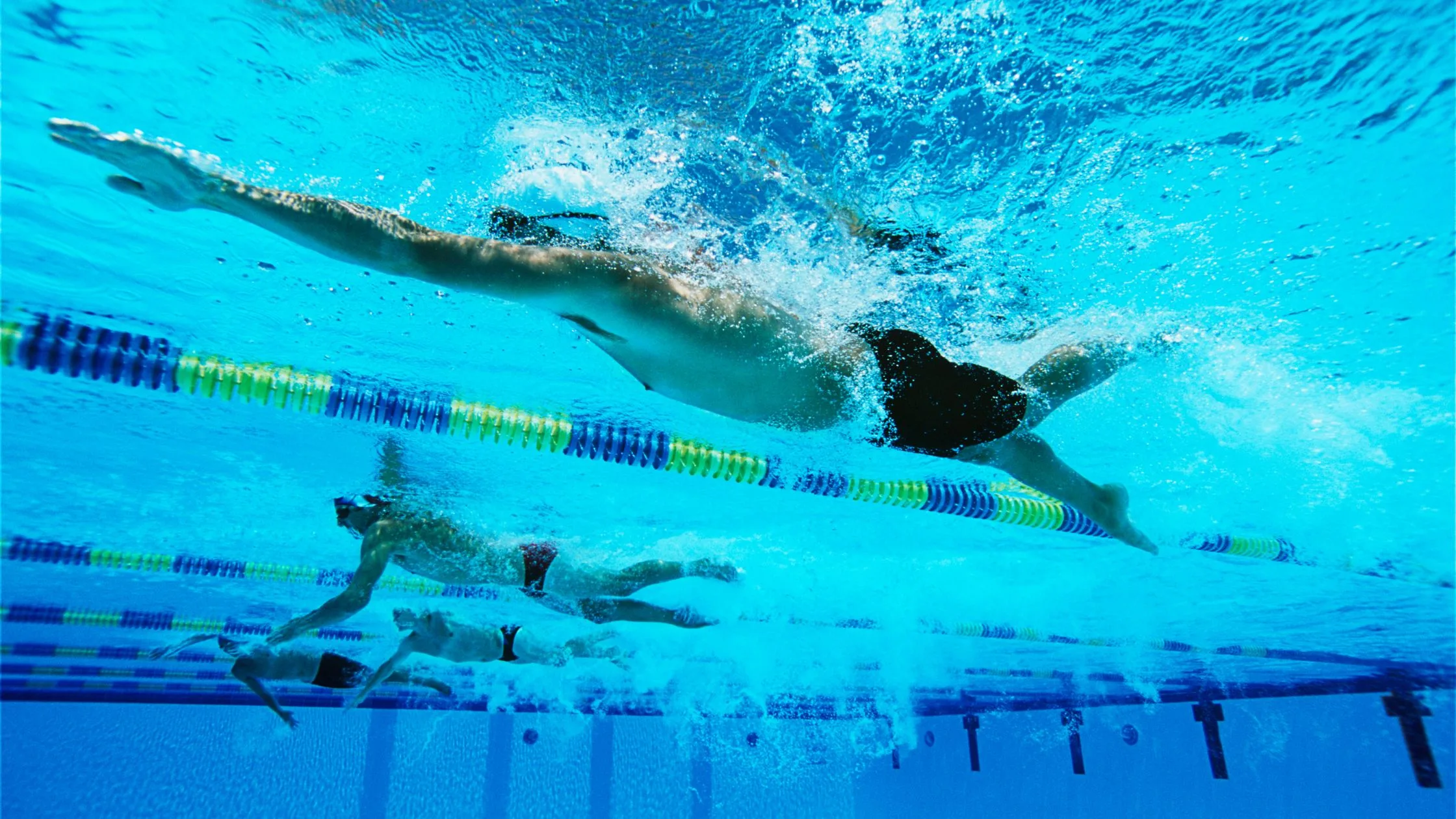 swimmers racing in pool Complete Pilates