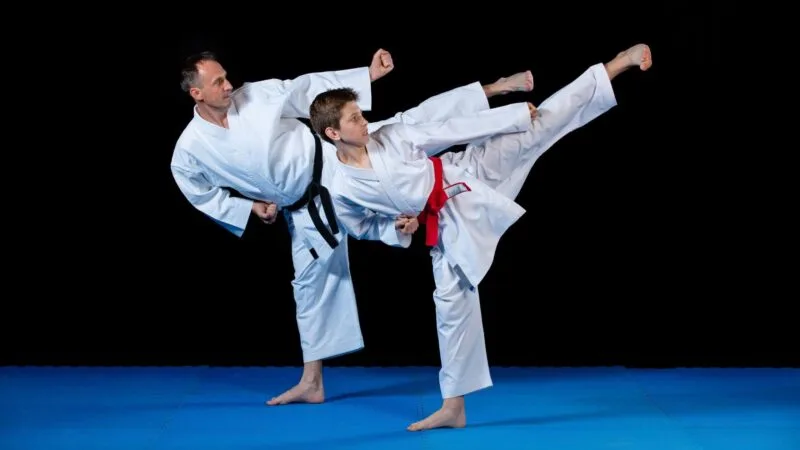 two men throwing karate kicks Complete Pilates