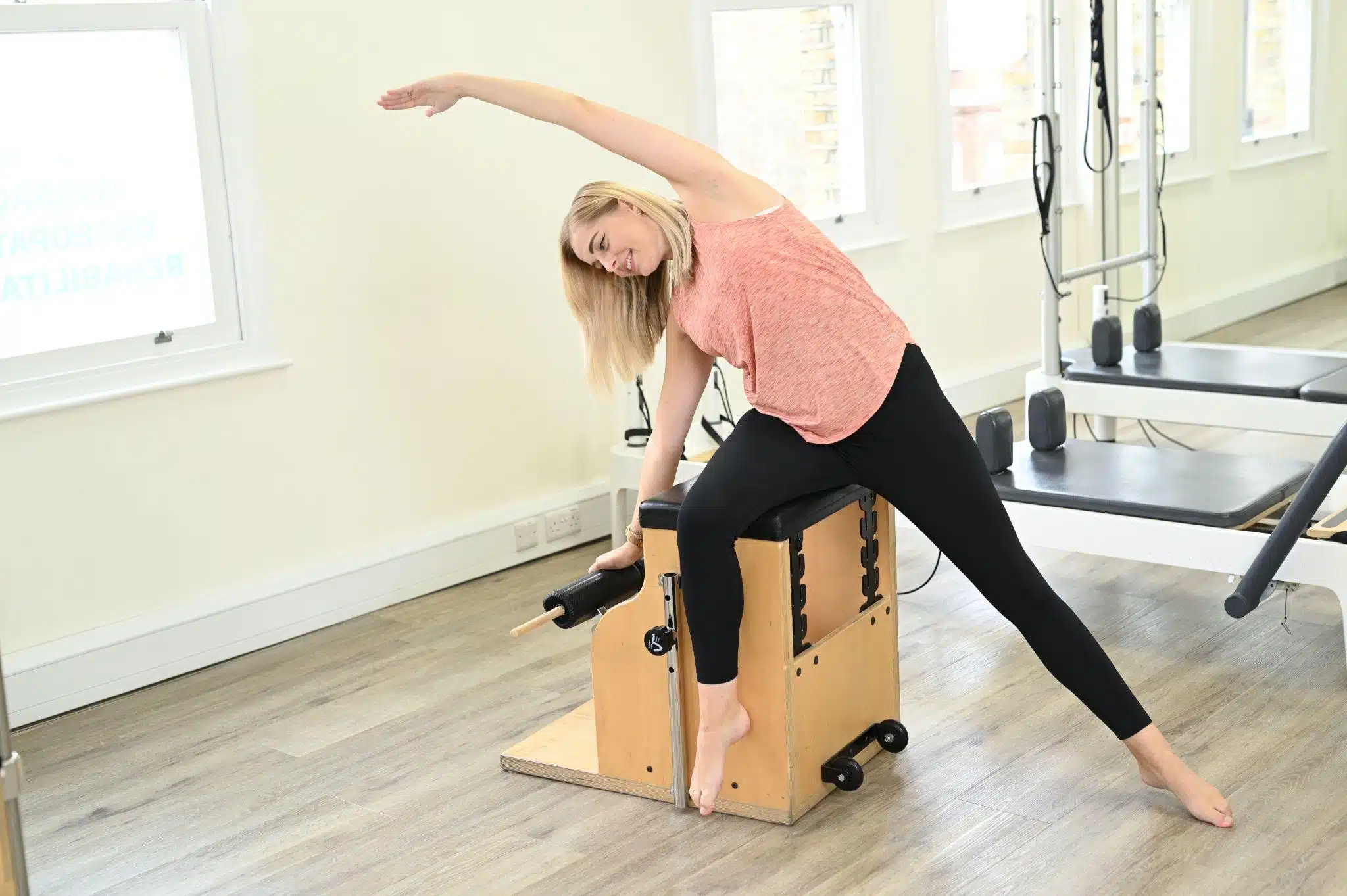 Woman performing an exercise on the Pilates Chair
