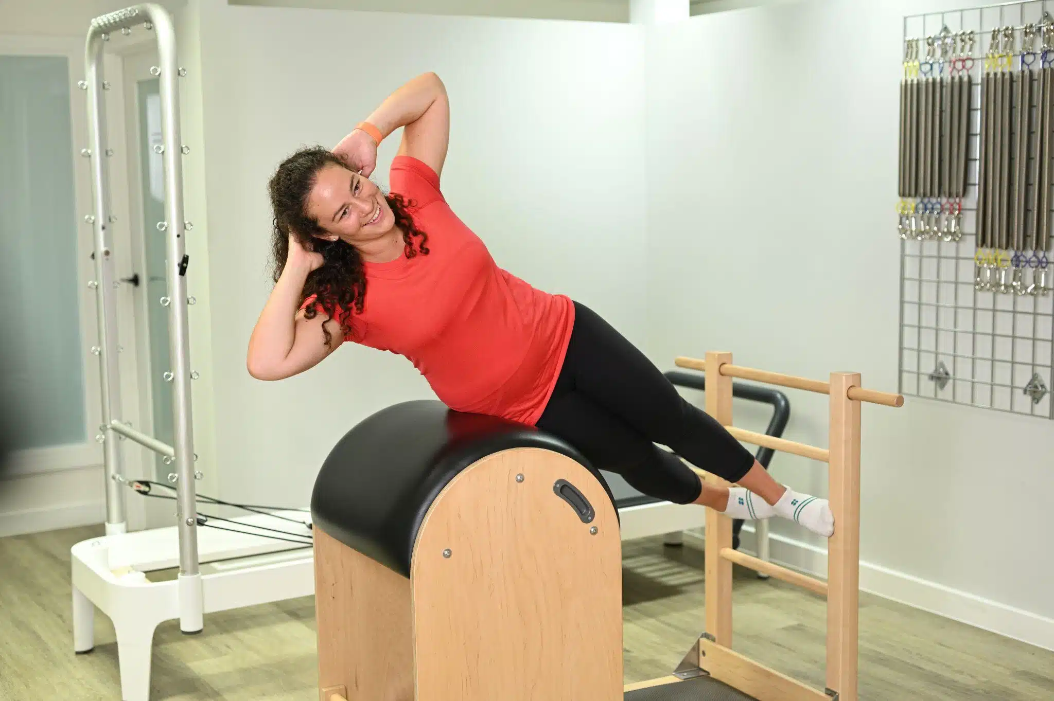 Woman performing an exercise on the Pilates Ladder-Barrell